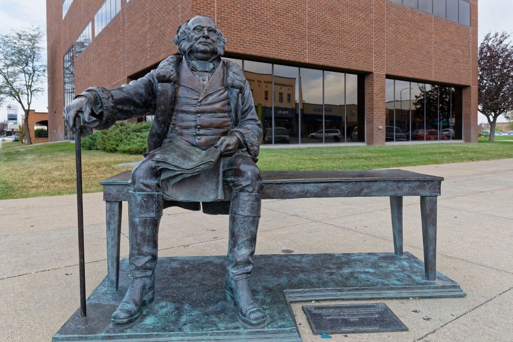 A sitting bronze sculpture of a president at Rapid City