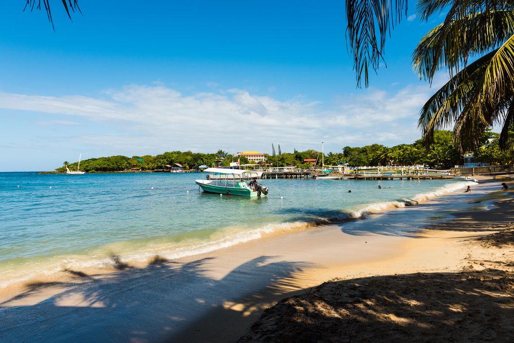 A boat on the waters of West Bay Beach