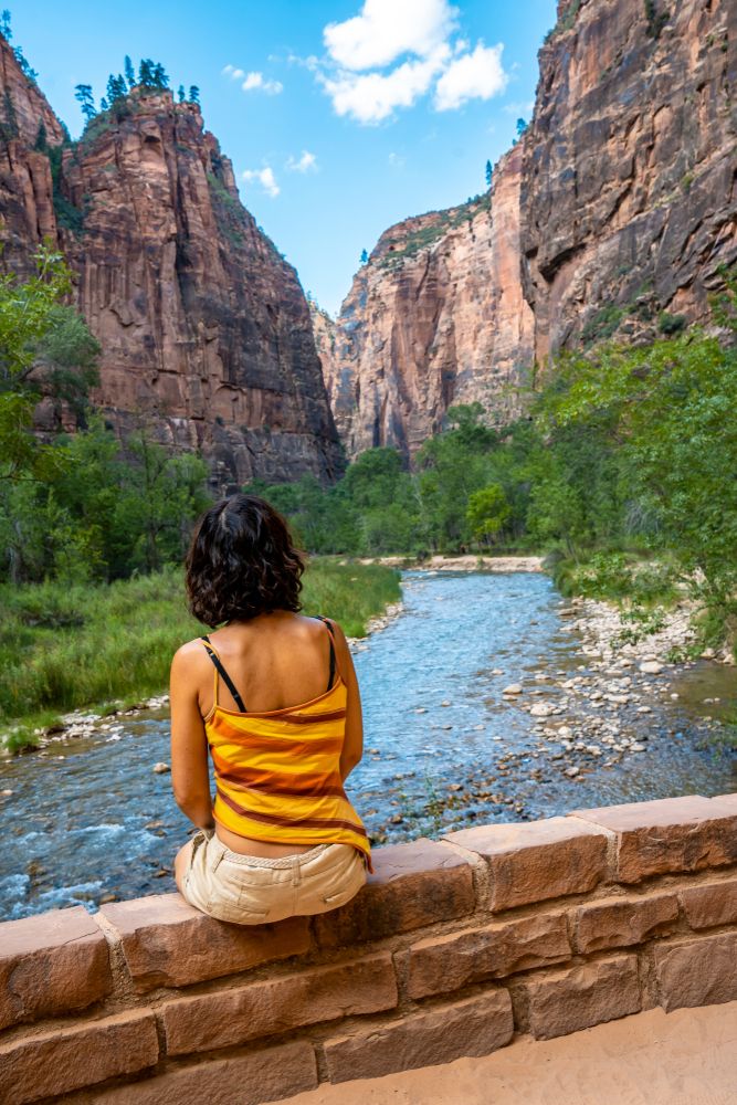 A young woman mesmerizied by the waters flowing in Riverside Walk