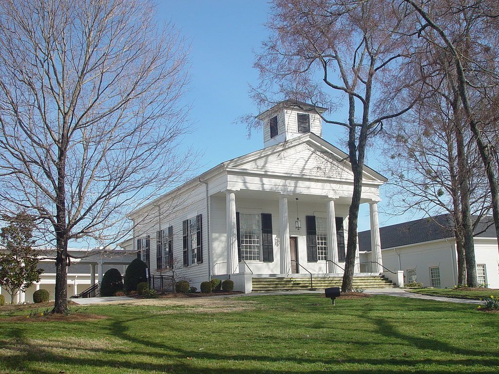 Sunny day view of the Roswell Presbyterian Church with white colored walls.