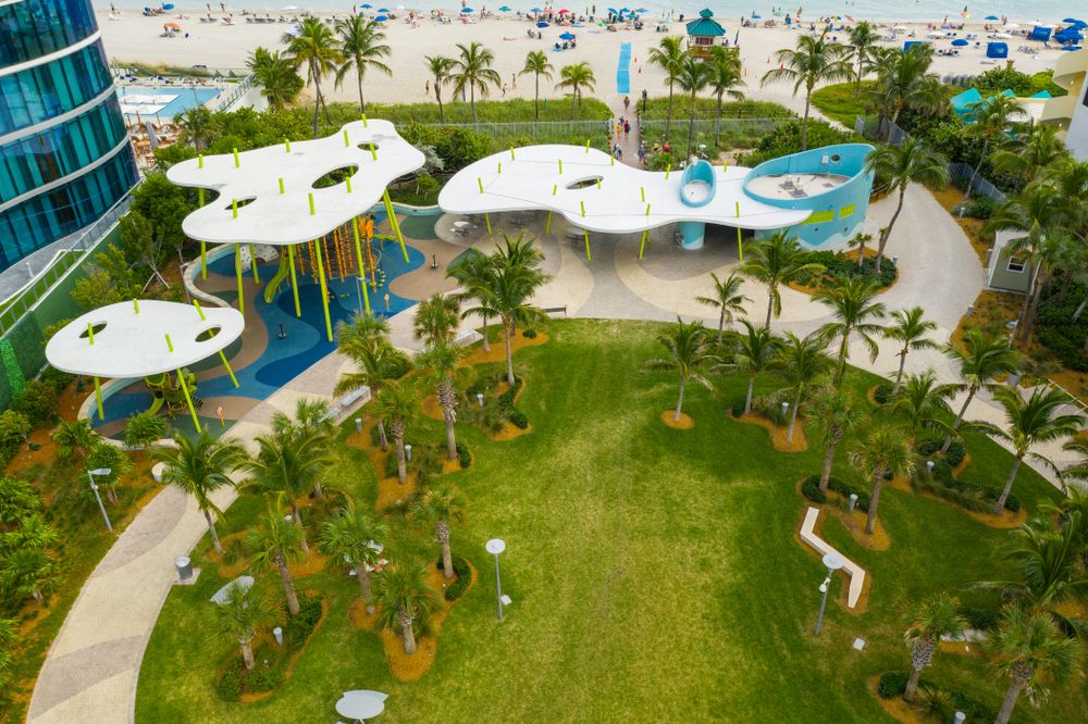 Aerial view of the palm trees and play area at Samson Oceanfront Park