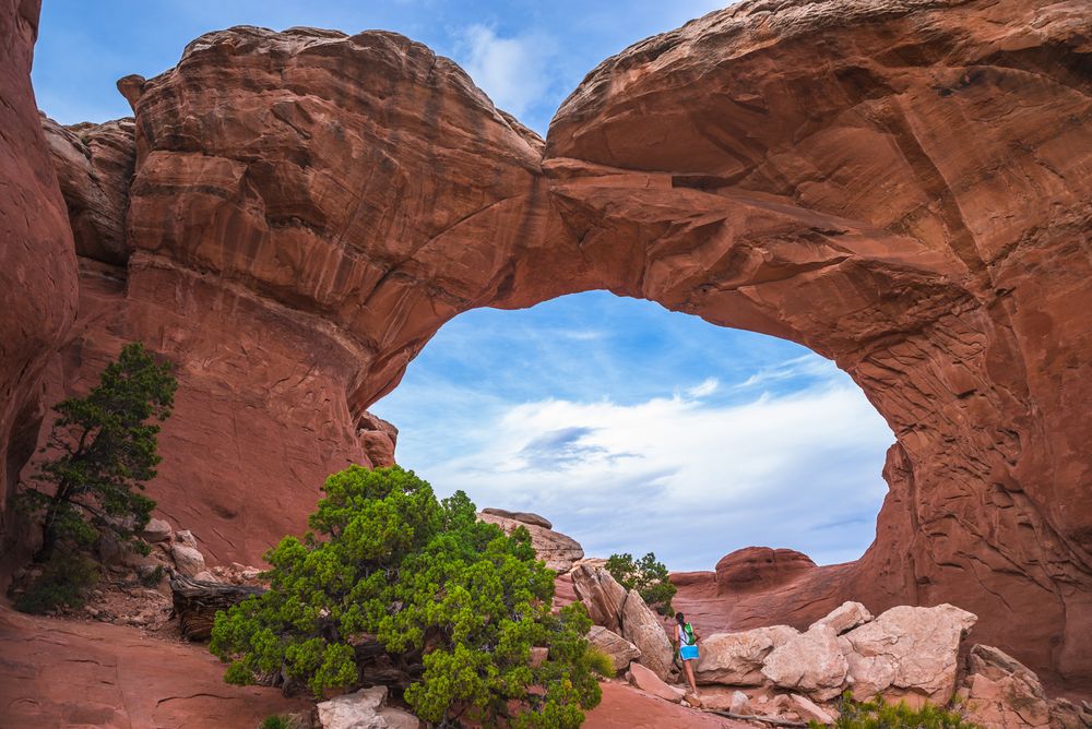 A woman exploring the Sand Dune Arch