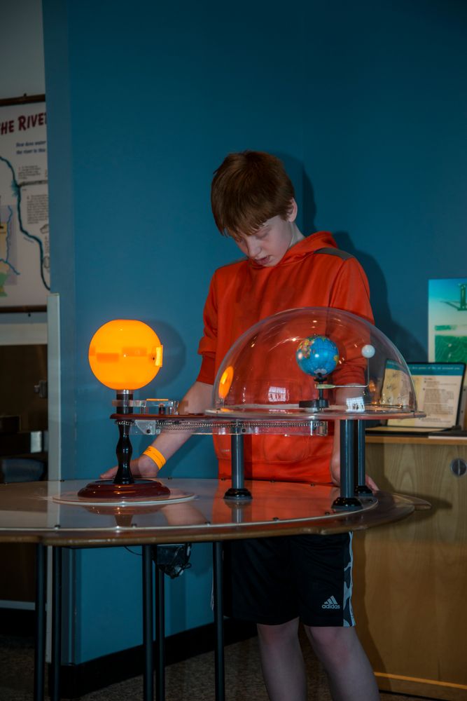 A young boy observing an experiment at the Science Museum of Minnesota