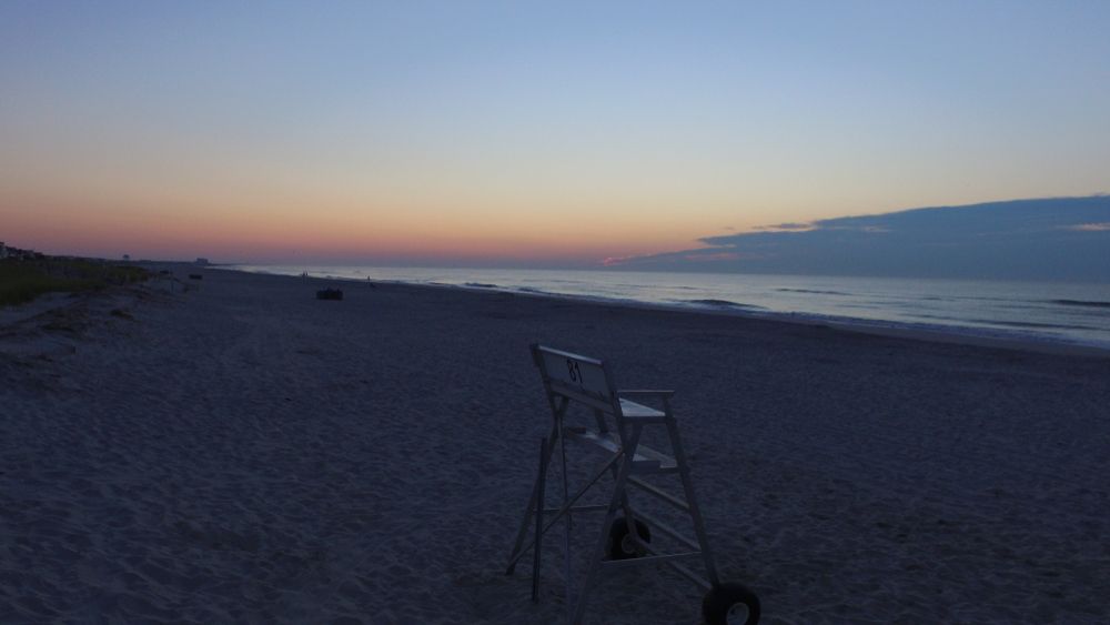 Empty chair and sunset at Sea Isle City Beach.