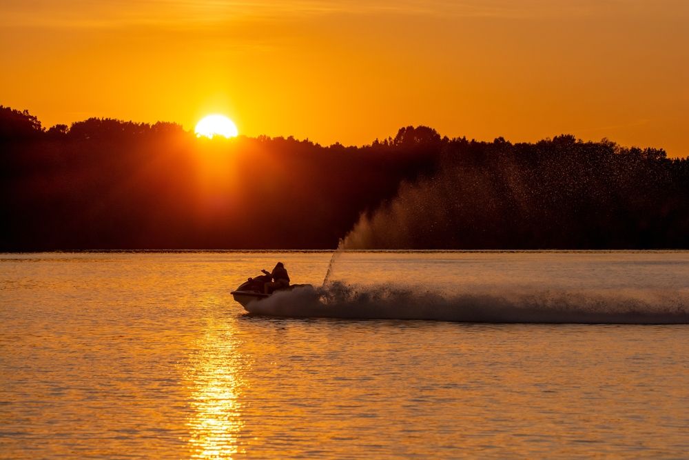 A person riding his jetski at Shenango River Lake during sunset