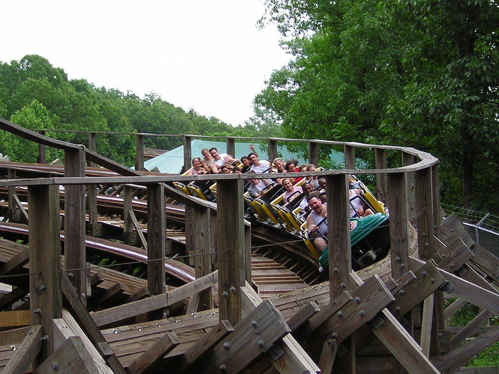 People riding a wooden rollercoaster.
