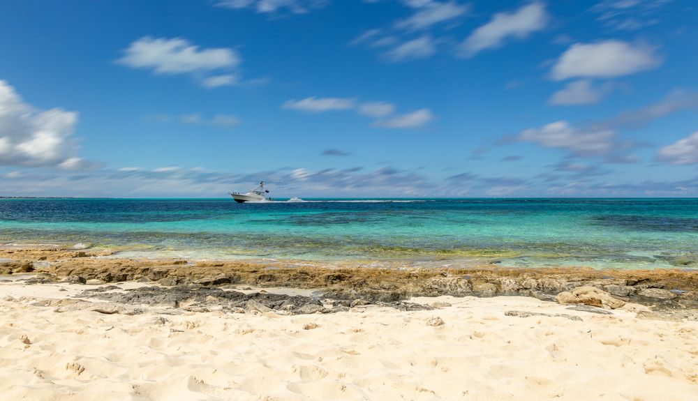A boat sailing through the blue water at Smith’s Reef