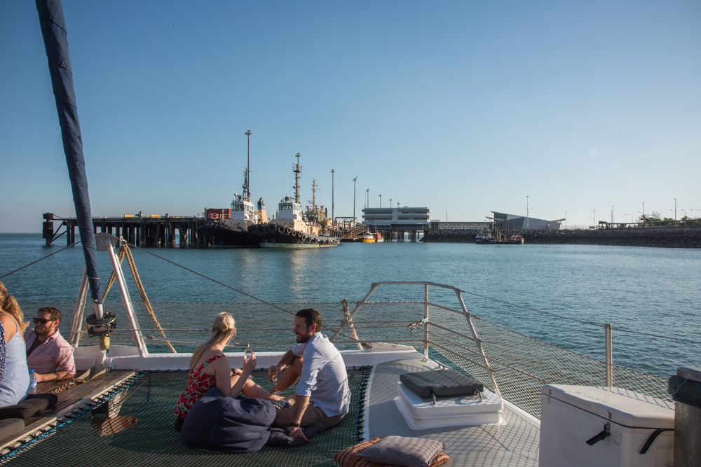 A young couple enjoying the view of Stokes Hill Wharf from a cruise