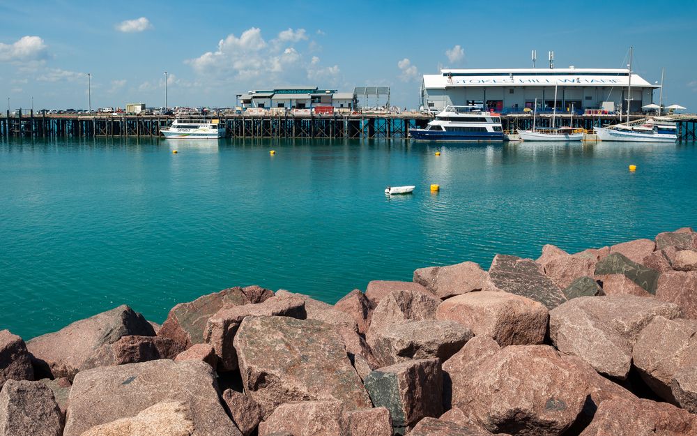 Strokes Hill Wharf with blue water of the ocean and rocks in the forefront