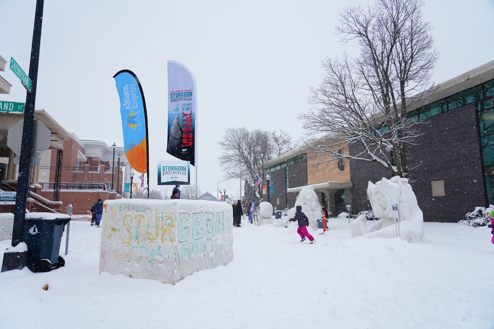 Kids playing in the snow outside the Thelma Sadoff Center For the Arts