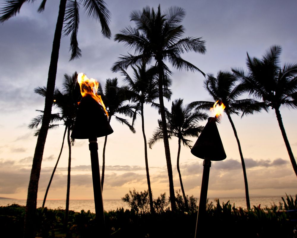Torches lit up during night at Wailea Beach