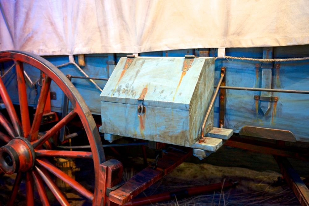 A red coloured wheel and a white chest box.
