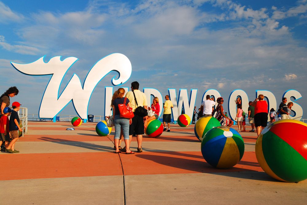 People admiring the Wildwoods Sign