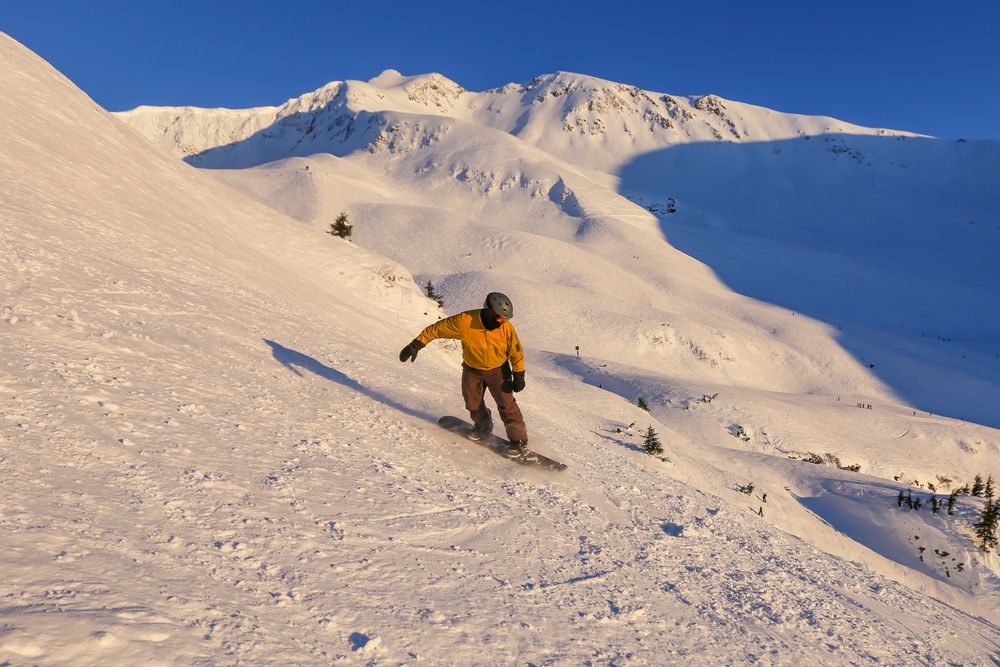 Snowboarder going downhill at Alyeska Resort
