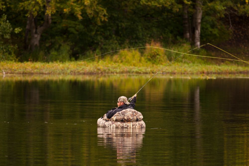 A man fly fishing on Kincaid Park's pond