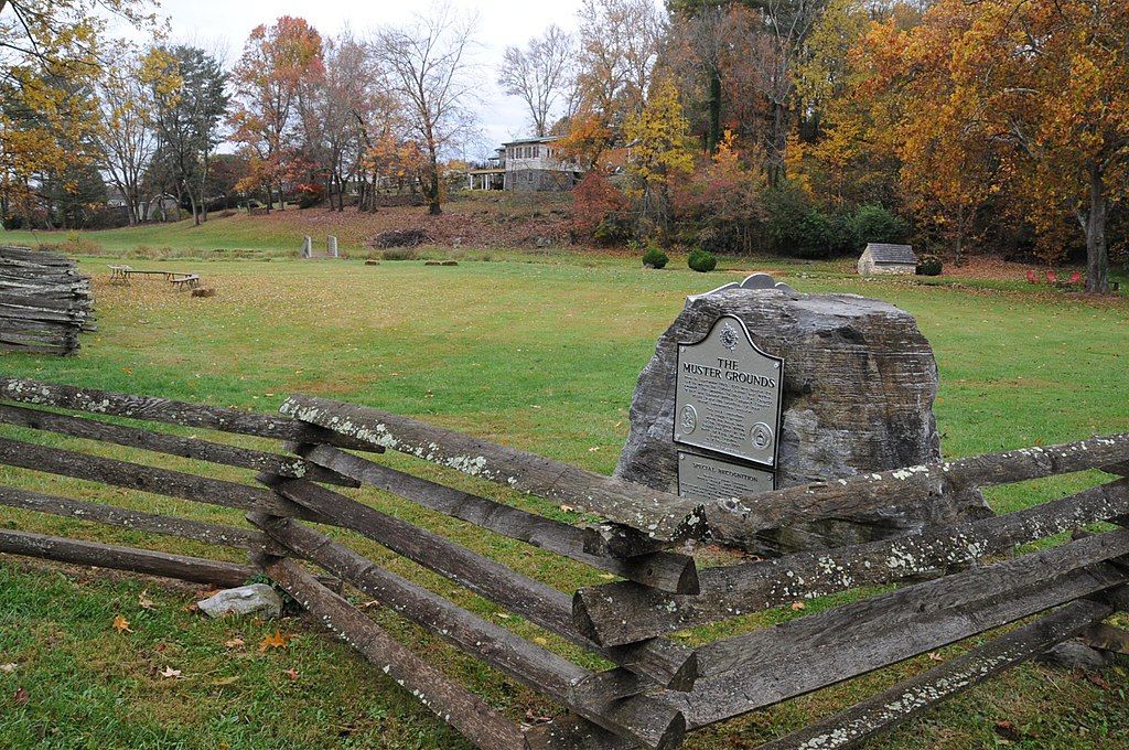 Abingdon muster grounds with horizontal wooden fence and autumn colored trees.