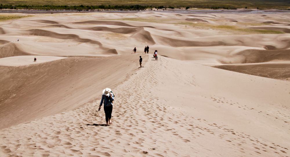 Hikers walking at Great Sand Dunes park.