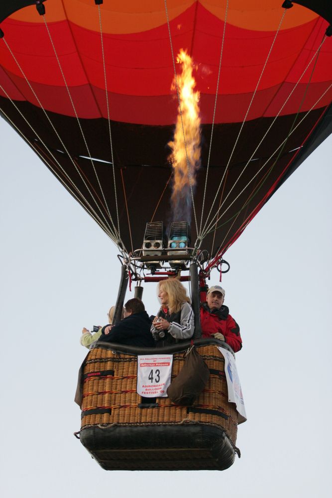 People on a hot air balloon during the Adirondack Balloon Festival