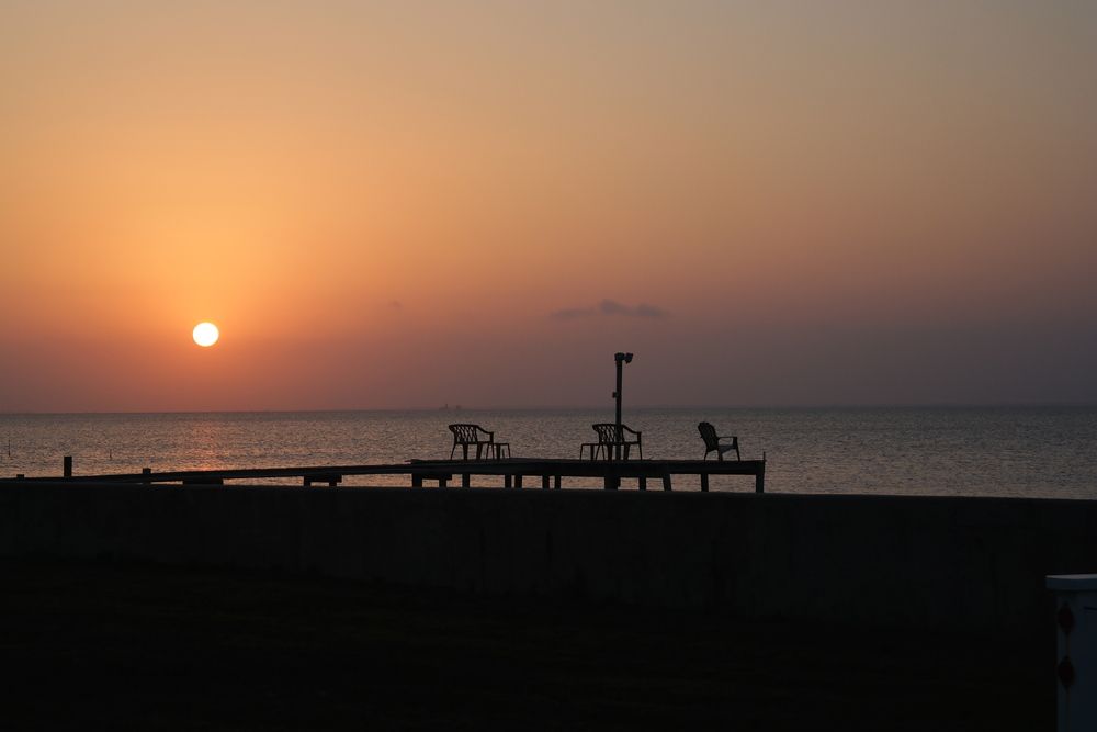 Silhouette of a pier at Rockport Beach