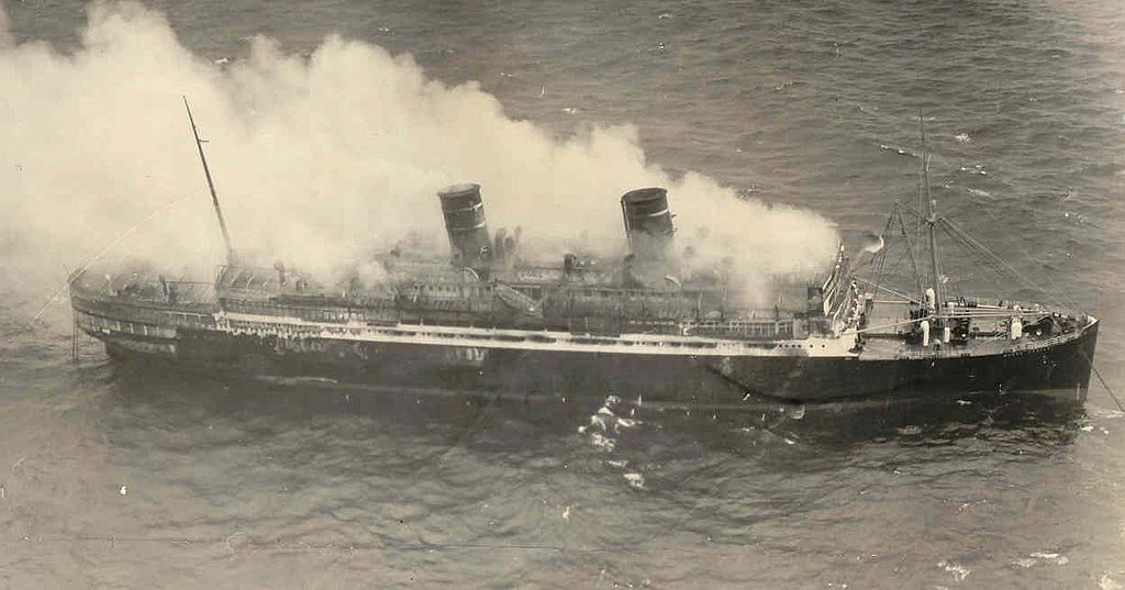 Old photograph of the burning SS Morro Castle in the middle of the sea