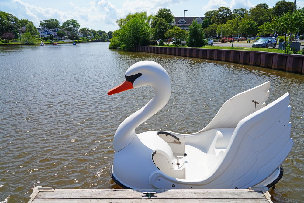 An empty swan-shaped boat docked at Wesley Lake