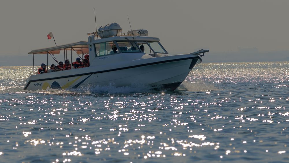 Tourists riding a boat at Al Dar Islands