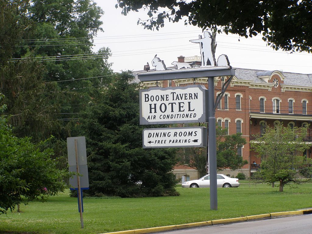 Sign post of boone tavern hotel along the road.
