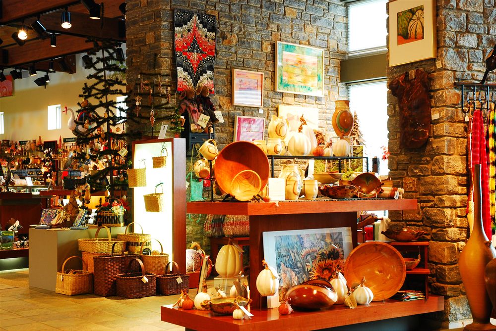Orange colored light inside the kentucky artisan center with their crafts on display.