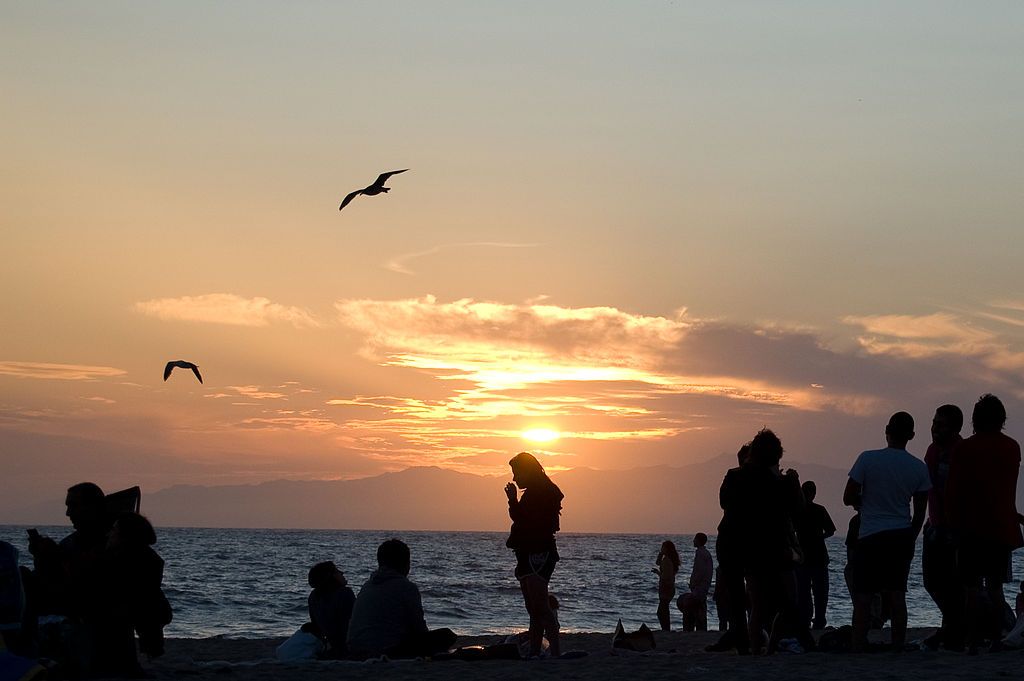People at Dockweiler Beach during sunset