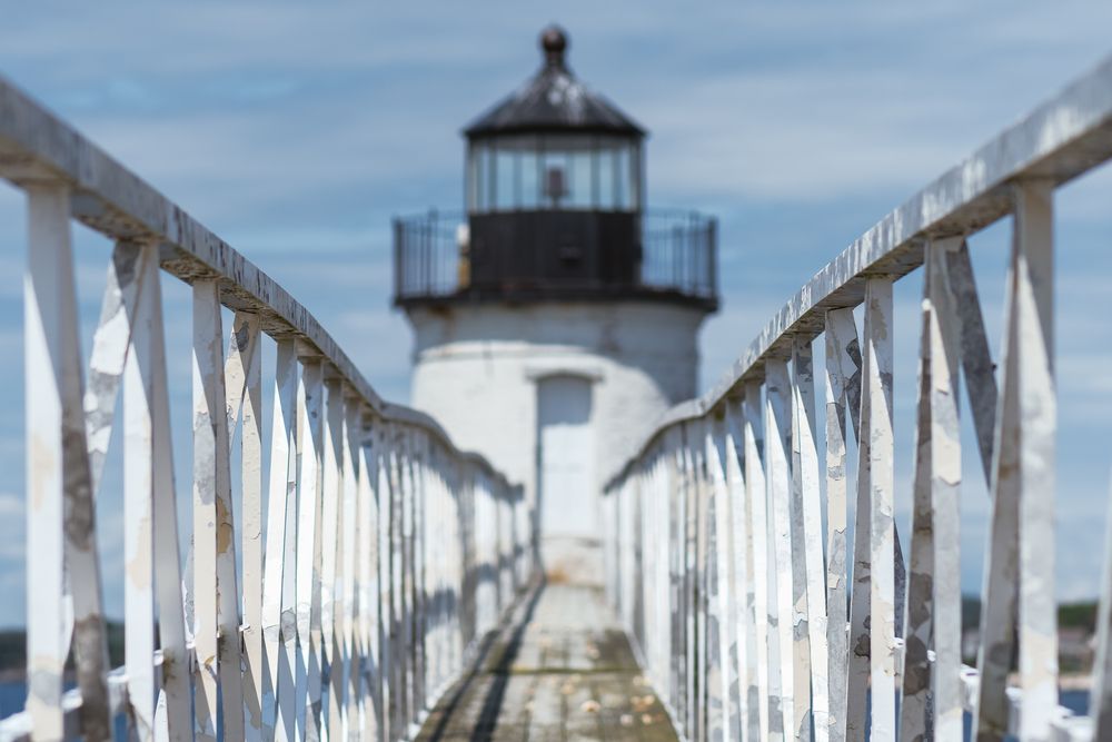 A wooden pier leading to the Ram Island Light