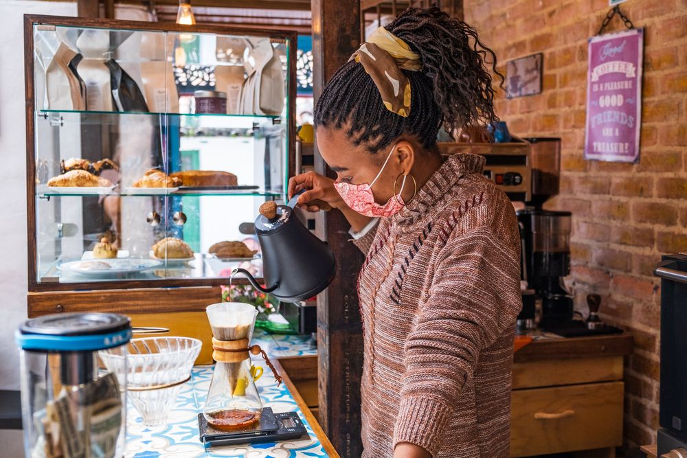 A barista making coffee in a coffee shop