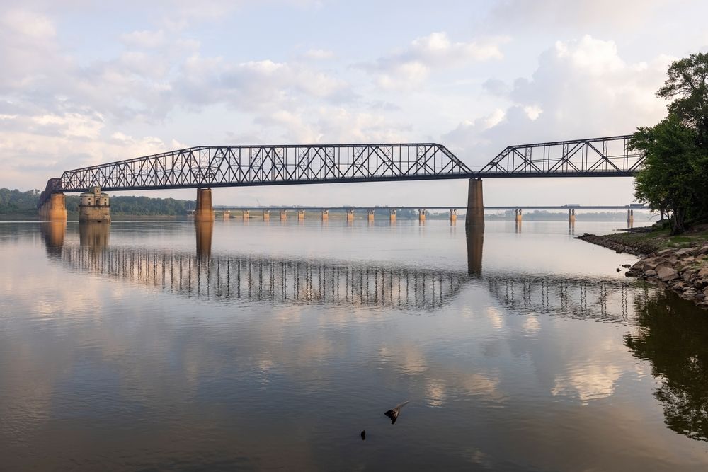 Body of water and chain rocks bridge.