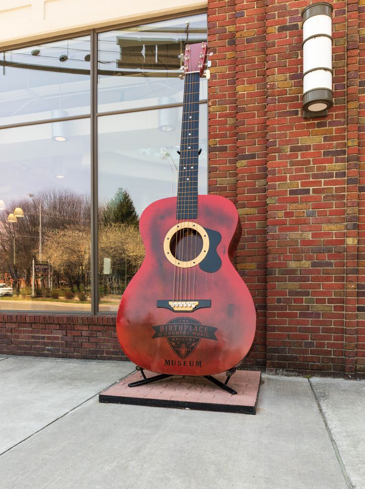 A vintage acoustic guitar in front of Country Music Museum