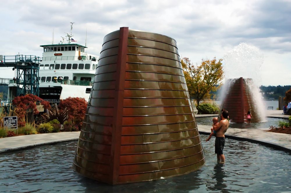 People enjoying the waters of a fountain at Harborside Fountain Park