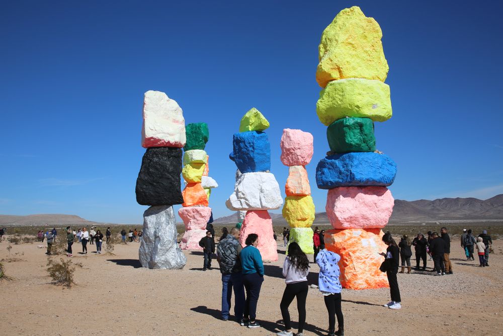 People admiring the Seven Magic Mountains