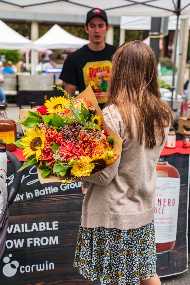 A person buying flowers at Vancouver Farmers Market