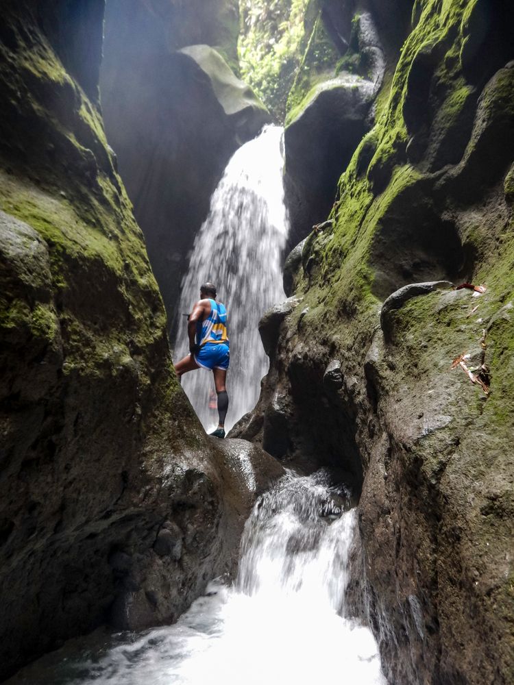 A Man Standing in Waterfall Les Gorges de la Falaise, Martinique