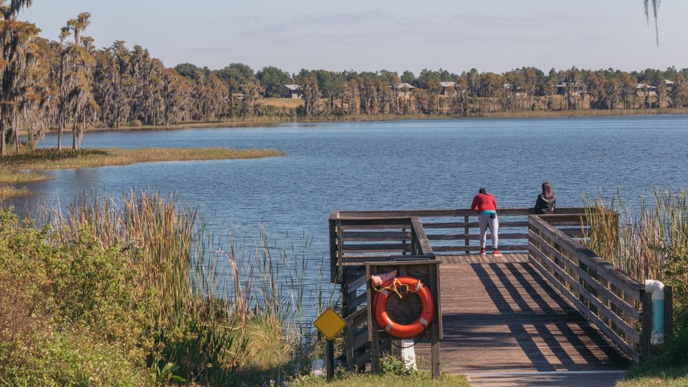 Two people on the dock of Lake Louisa State Park