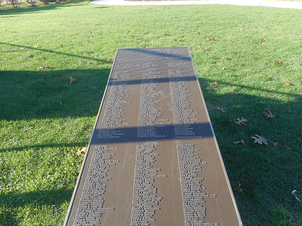 Long honor roll plaque on the grounds of Grumman Memorial Park