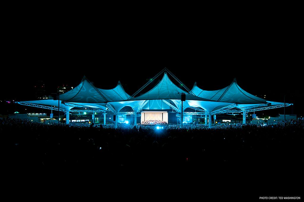 The Cynthia Woods Mitchell Pavilion Star-Spangled Salute with blue lights - night time.