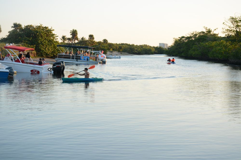 People paddling boats on top of a body of water.