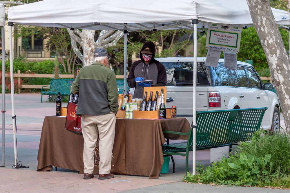 Shopper and vendor at Davis Farmers Market