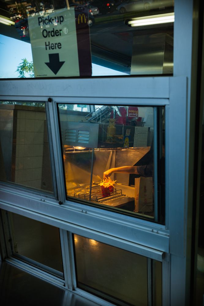 A worker preparing french fries at the World's Oldest McDonald's