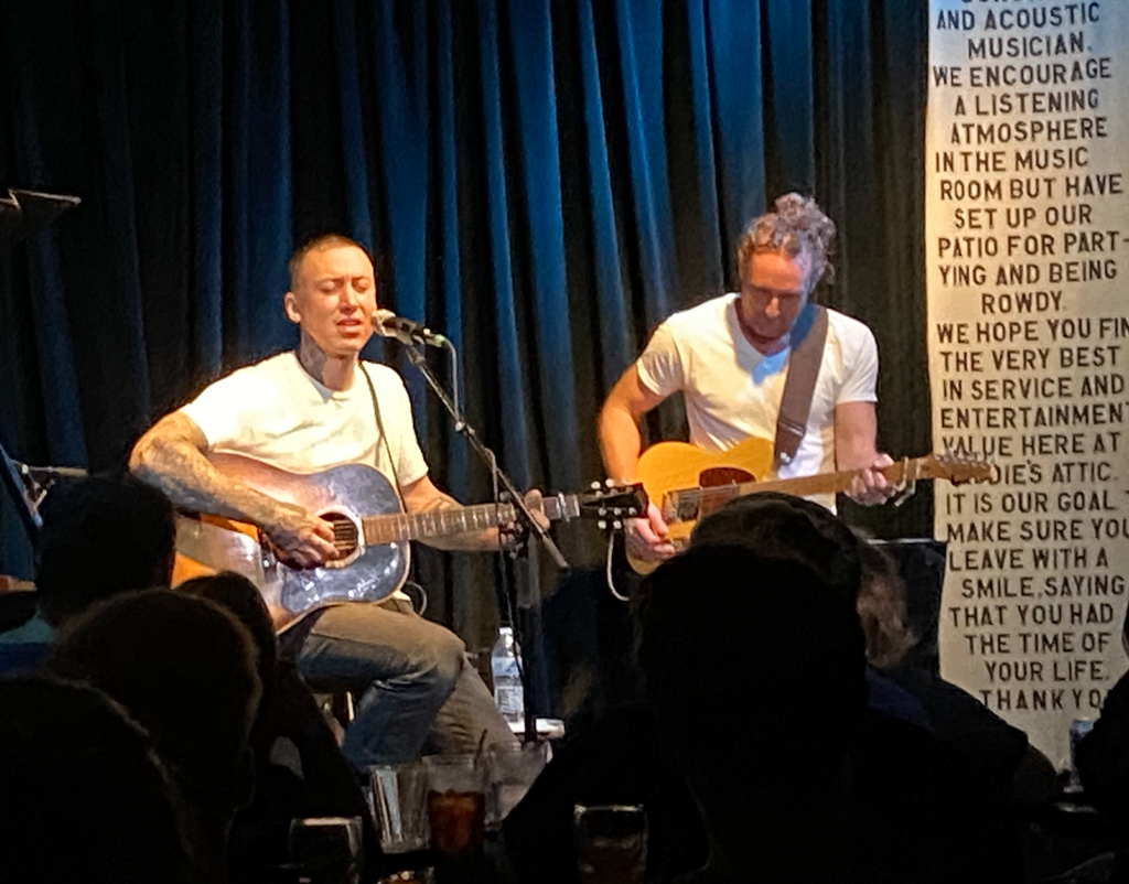 Two men performing with acoustic guitars at eddie's attic.