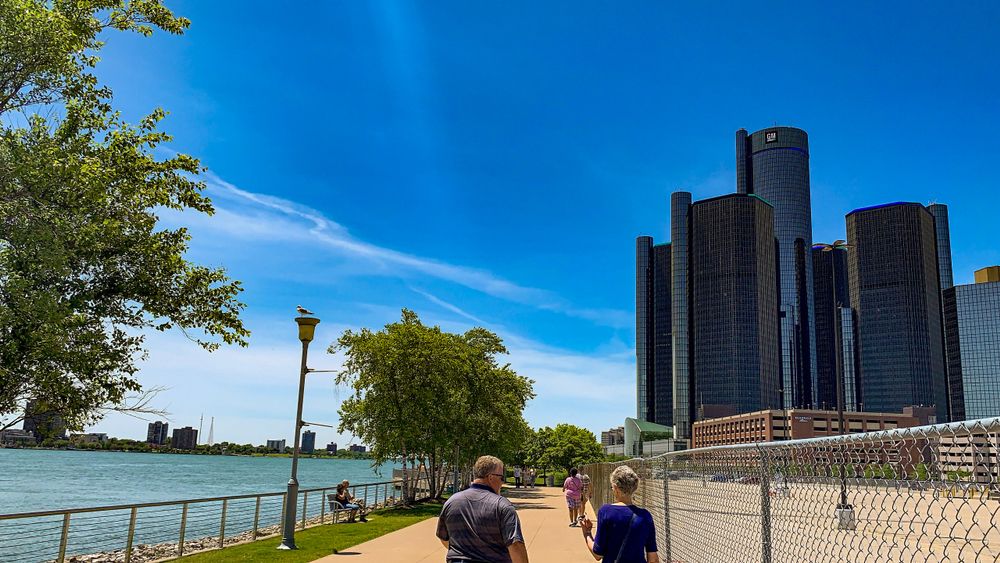 People walking along Detroit Riverwalk Park