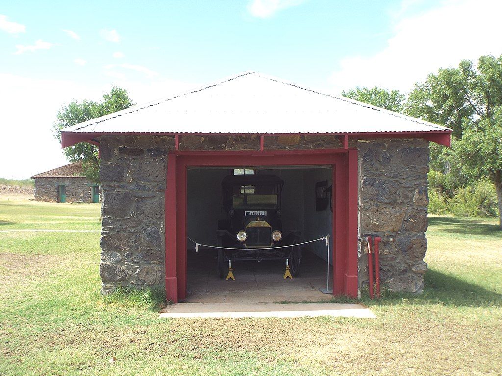 A vintage vehicle under a shed at Slaughter Ranch Museum