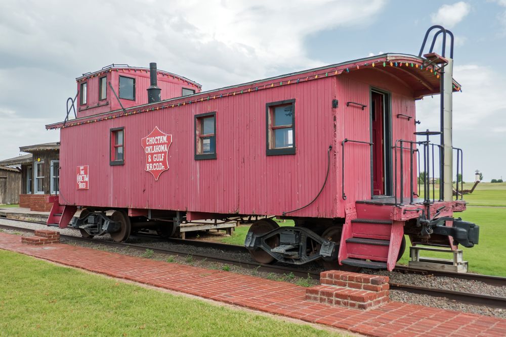 A train caboose on the grounds of National Transportation Museum
