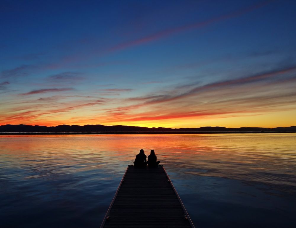 Two people admiring Lake Champlain