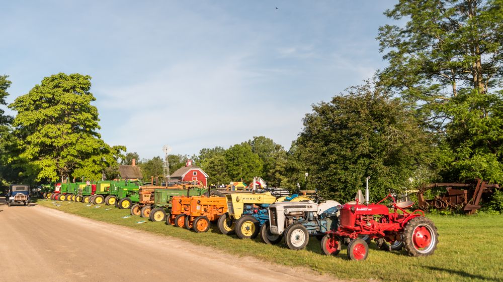 Row of vintage vehicles at Crossroads Village and Huckleberry Railroad