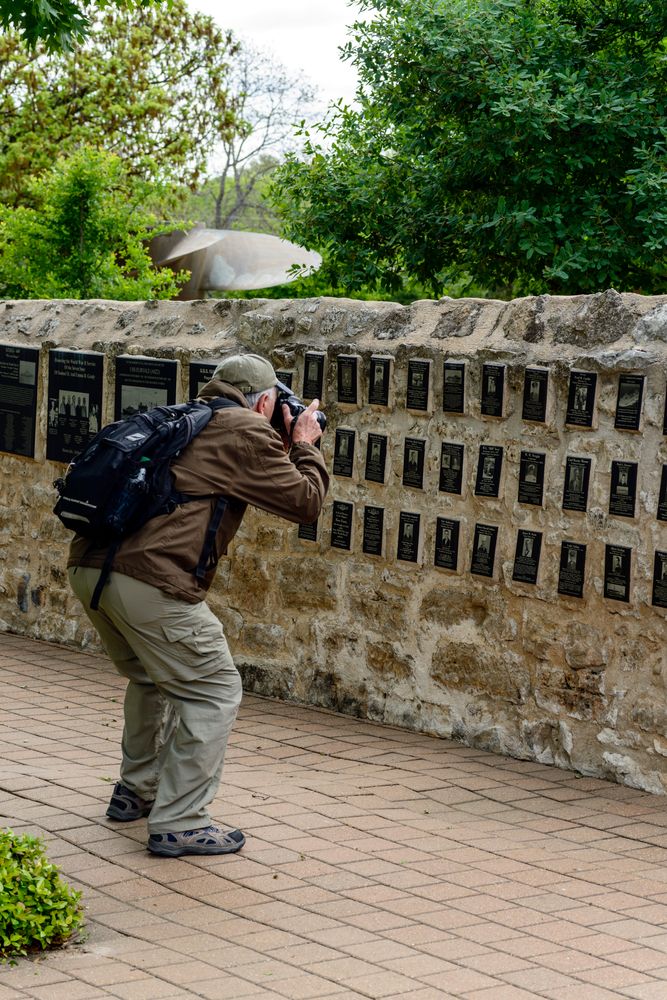 A person taking a picture of National Museum of the Pacific War's memorial walk